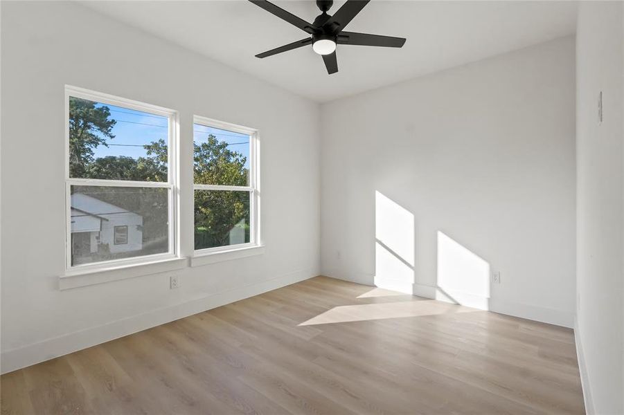 Spare room with light wood-style flooring and a ceiling fan