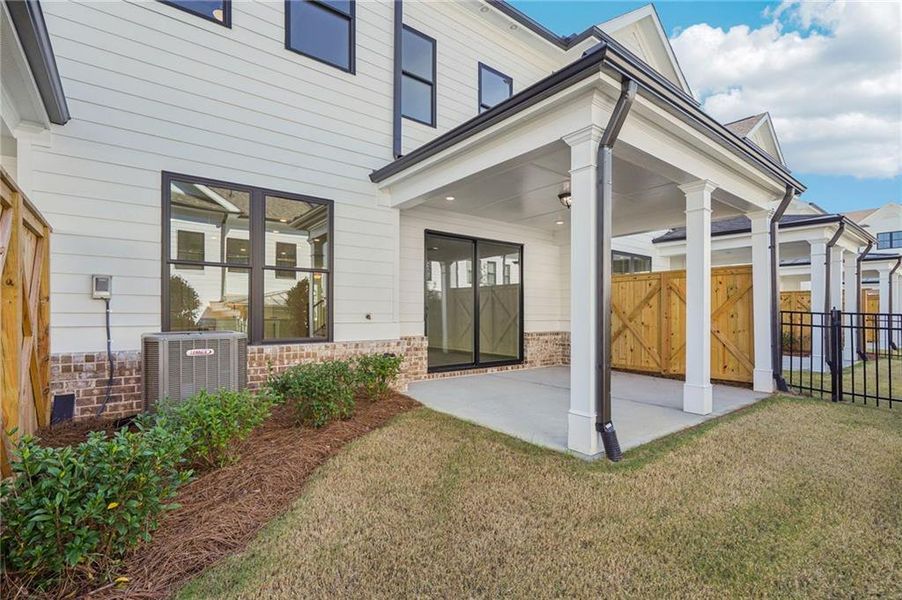 Exterior details and patio area of a home in Millcroft Townhomes, Buford (Image 4).