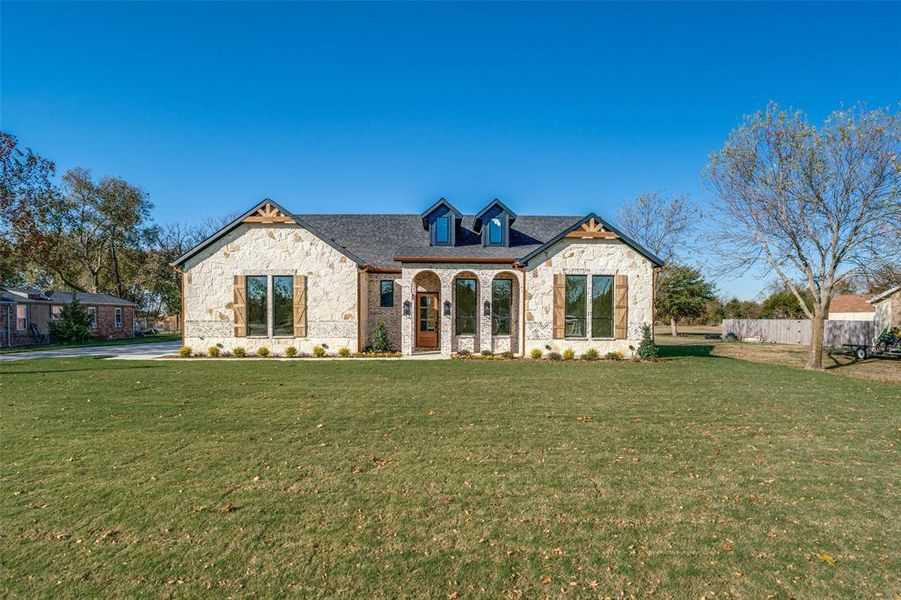 View of front facade with stone siding, covered porch, and brick siding View of front facade with stone siding, covered porch, and brick siding