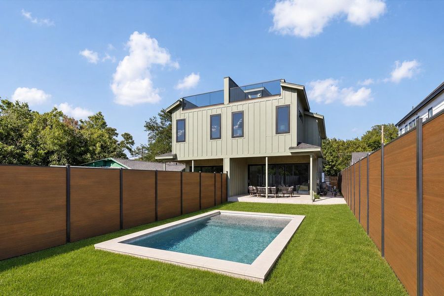 A private backyard oasis features a sparkling in-ground pool and an inviting patio for outdoor entertaining.
