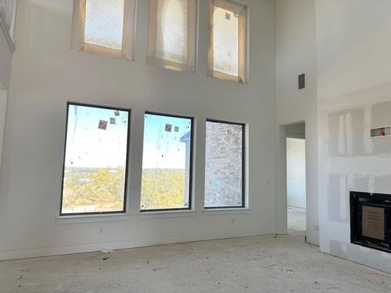 Family Room with soaring ceiling & fireplace