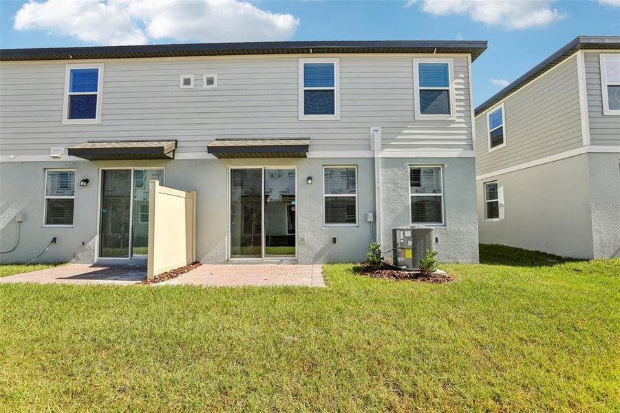 Exterior details and patio area of a home in The Meadow at Crossprairie Townes, St. Cloud (Image 3).
