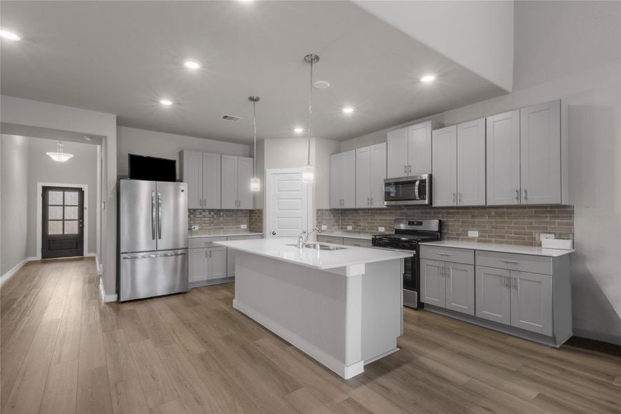Modern and functional kitchen featuring generous counter space, ample cabinetry, and a practical layout ideal for both daily cooking and hosting guests. The kitchen seamlessly connects to the main living areas for easy interaction.