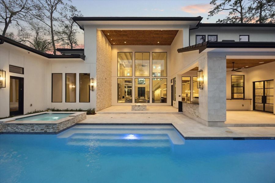 Walls of glass seamlessly connect the indoor living spaces to the resort-style pool, creating a stunning indoor-outdoor living experience filled with natural light. Walls of glass seamlessly connect the indoor living spaces to the resort-style pool, creating a stunning indoor-outdoor living experience filled with natural light.