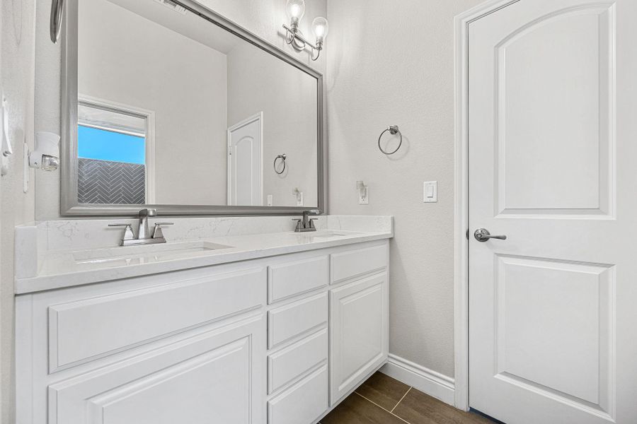 Double vanity with stone counters and modern fixtures, perfect for daily routines. Double vanity with stone counters and modern fixtures, perfect for daily routines.