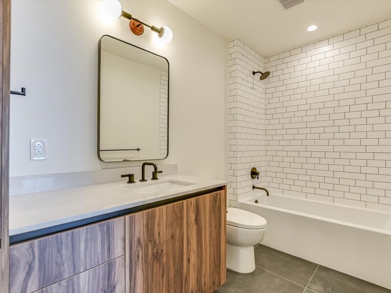 Secondary bathroom with garden tub/shower combo.