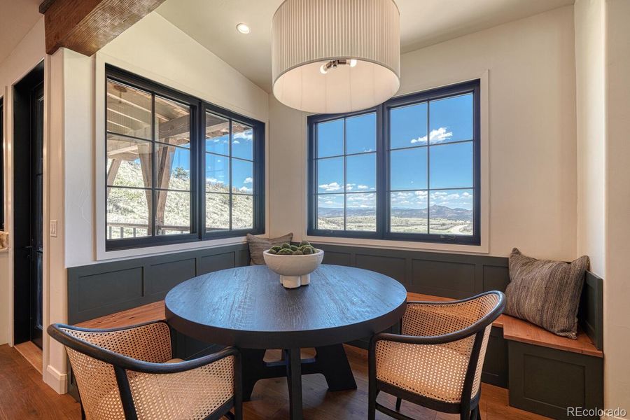 A built-in banquette breakfast nook sits beside oversized windows that look east toward Pikes Peak, offering the perfect place to start the day with a sunrise view. A built-in banquette breakfast nook sits beside oversized windows that look east toward Pikes Peak, offering the perfect place to start the day with a sunrise view.
