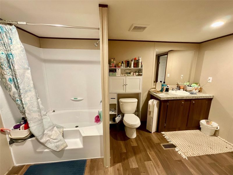 Bathroom featuring a white bathtub and shower combination