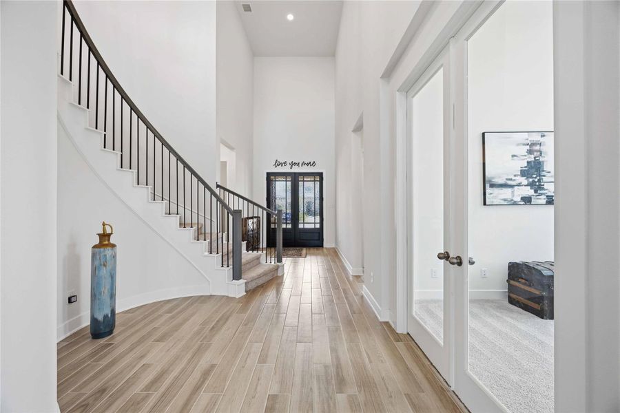 A dramatic entry showcases soaring ceilings, sophisticated finishes, and an immediate sense of scale and luxury.