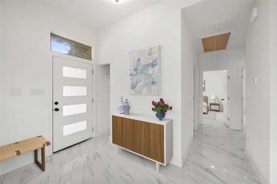 Foyer featuring light marble finish flooring Foyer featuring light marble finish flooring