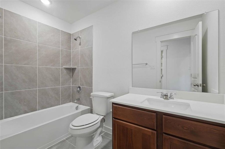 Bathroom featuring vanity, shower / bathtub combination, and tile patterned flooring Bathroom featuring vanity, shower / bathtub combination, and tile patterned flooring
