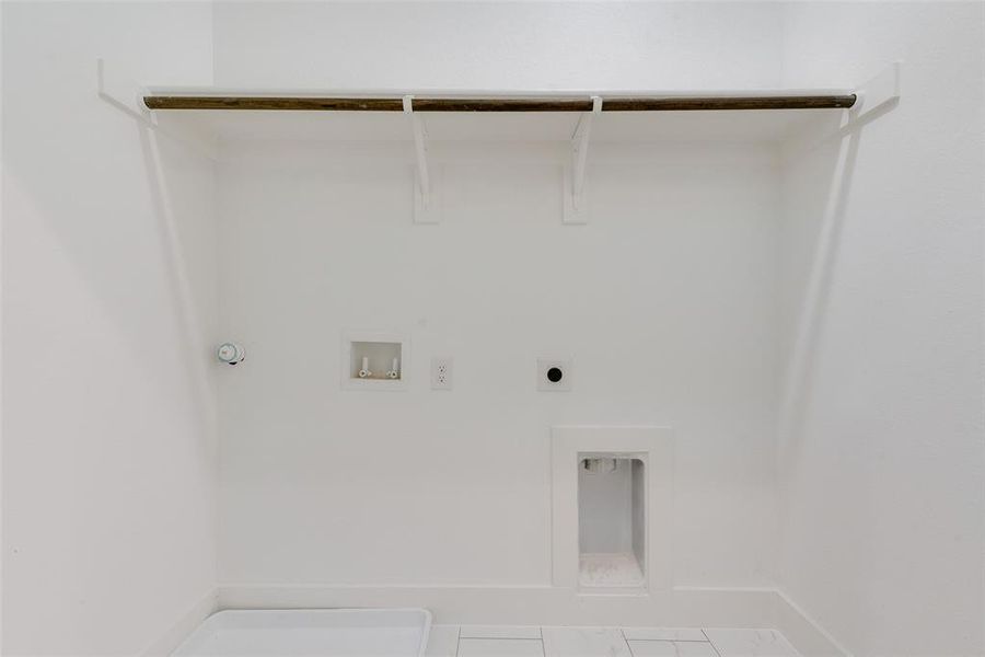 Laundry room featuring hookup for a washing machine, tile patterned floors, hookup for an electric dryer, and hookup for a gas dryer Laundry room featuring hookup for a washing machine, tile patterned floors, hookup for an electric dryer, and hookup for a gas dryer