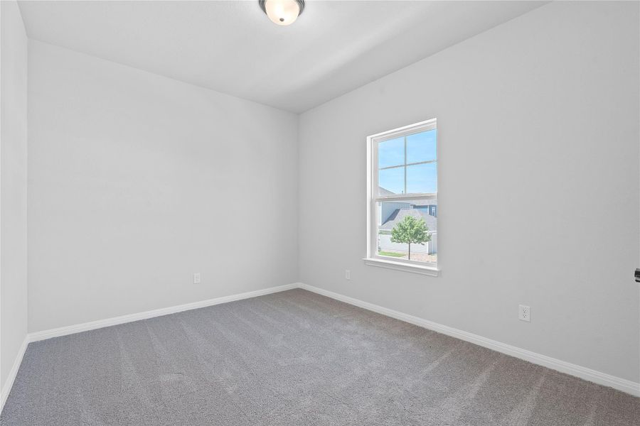 Carpeted empty room with baseboards
