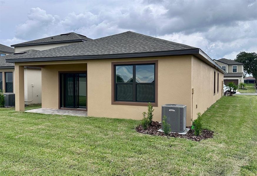 Front exterior of a new home in Grasslands West, Lakeland, FL, highlighting curb appeal (Image 16).