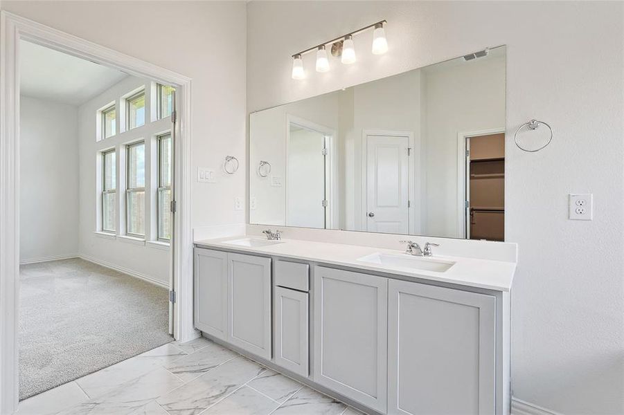 Bathroom featuring dual vanity and tile patterned floors