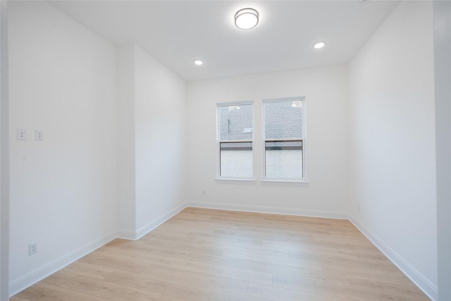 Spare room featuring light wood-style flooring and recessed lighting