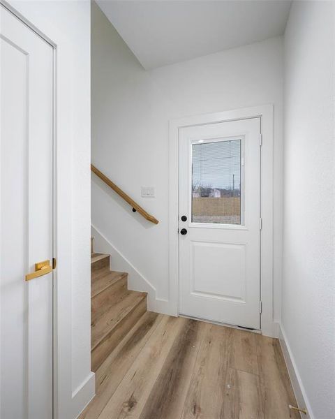 Doorway to outside featuring light wood-type flooring