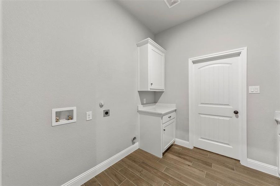 Laundry room with cabinets, washer hookup, and electric dryer hookup