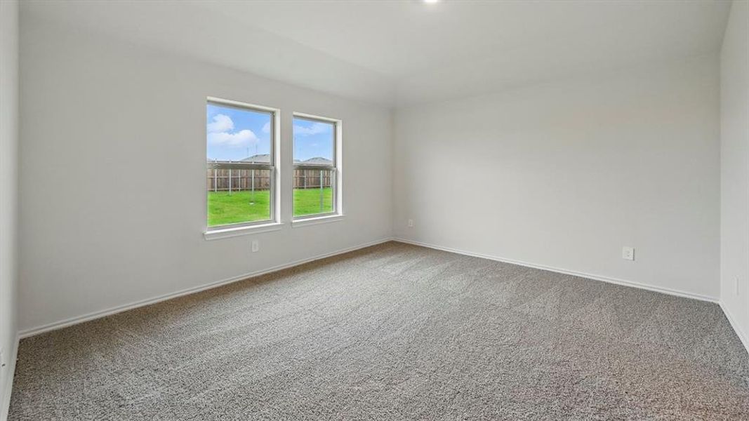 Spare room with light carpet and baseboards