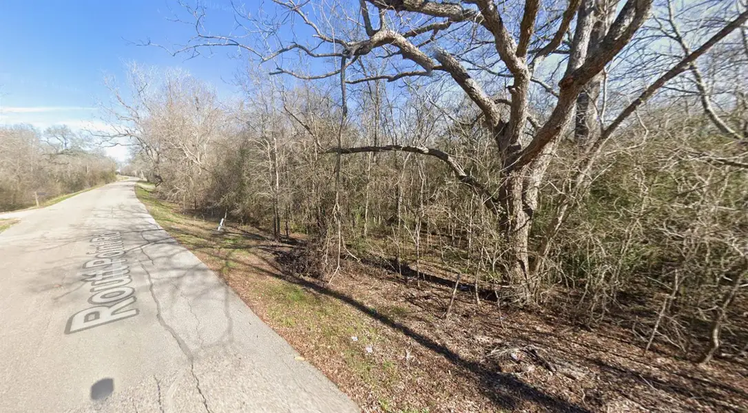 View of the property's frontage along Routt Point Road, showcasing the road access and front portion of the lot. View of the property's frontage along Routt Point Road, showcasing the road access and front portion of the lot.