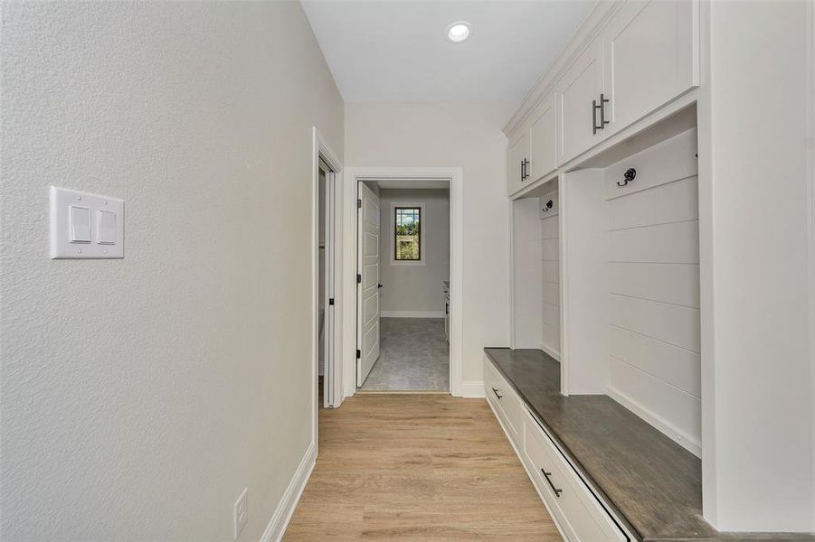 Mudroom with light hardwood / wood-style flooring