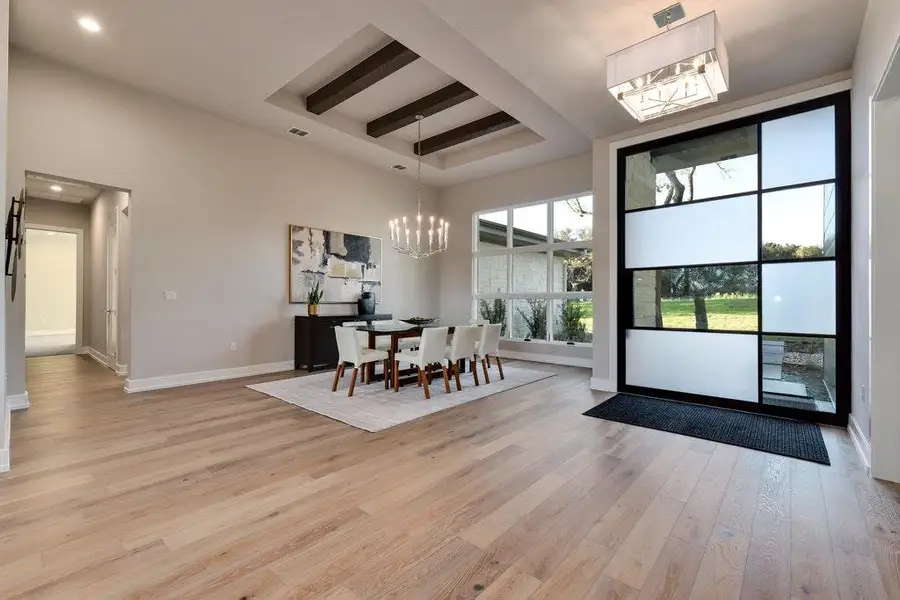Dining area flanked by beautiful steel modern door Dining area flanked by beautiful steel modern door