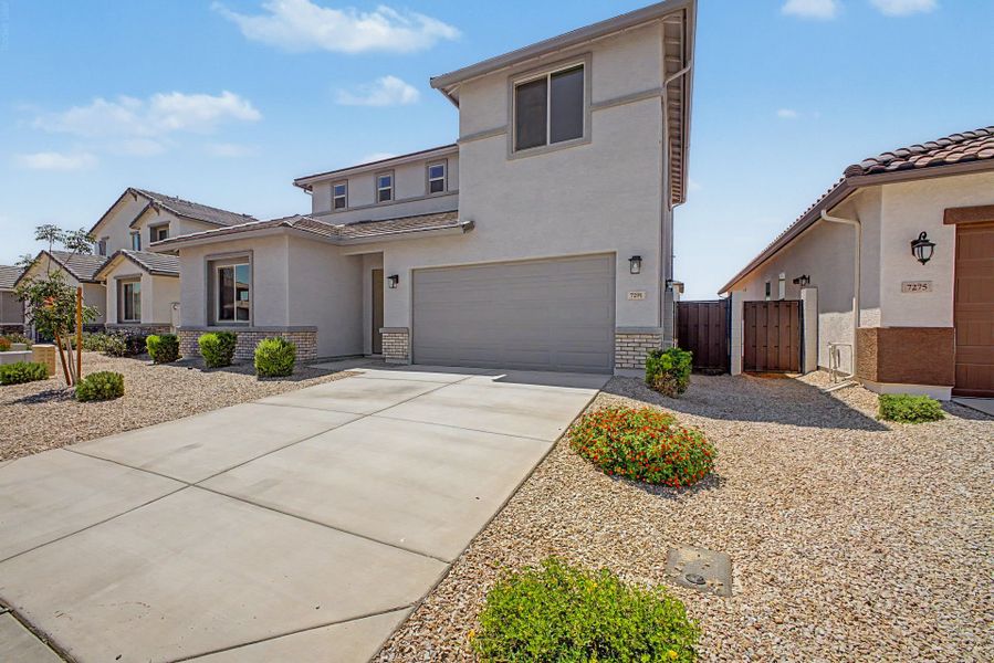 Front exterior of a new home in Wildera, San Tan Valley, AZ, highlighting curb appeal (Image 2). Front exterior of a new home in Wildera, San Tan Valley, AZ, highlighting curb appeal (Image 2).