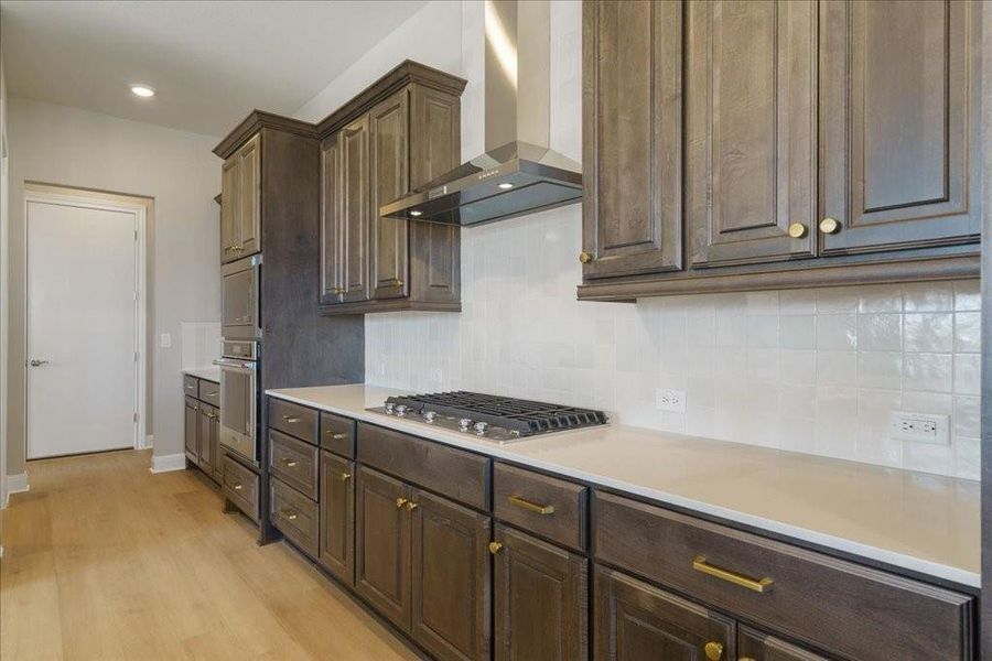 Upgraded backsplash, quartz countertops, and brand new stainless steel appliances elevate this beautiful kitchen even more.