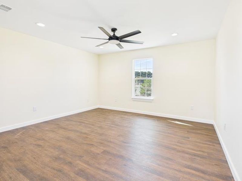 Before photo featuring dark wood-type flooring, a ceiling fan, and recessed lighting