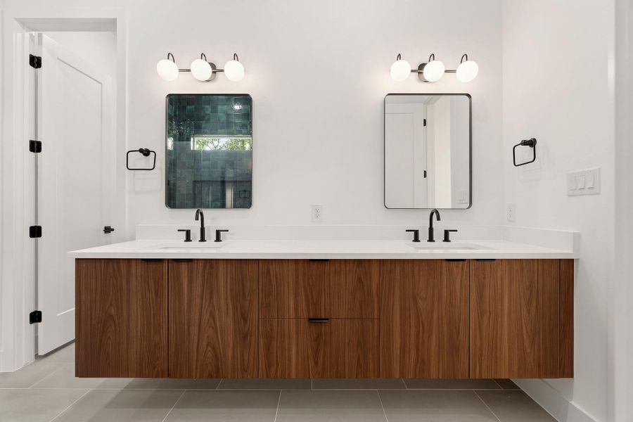 Bathroom featuring double vanity (floating) and light tile patterned floors