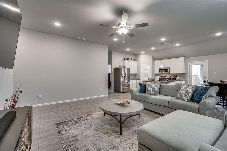 Living room featuring light wood-type flooring and ceiling fan