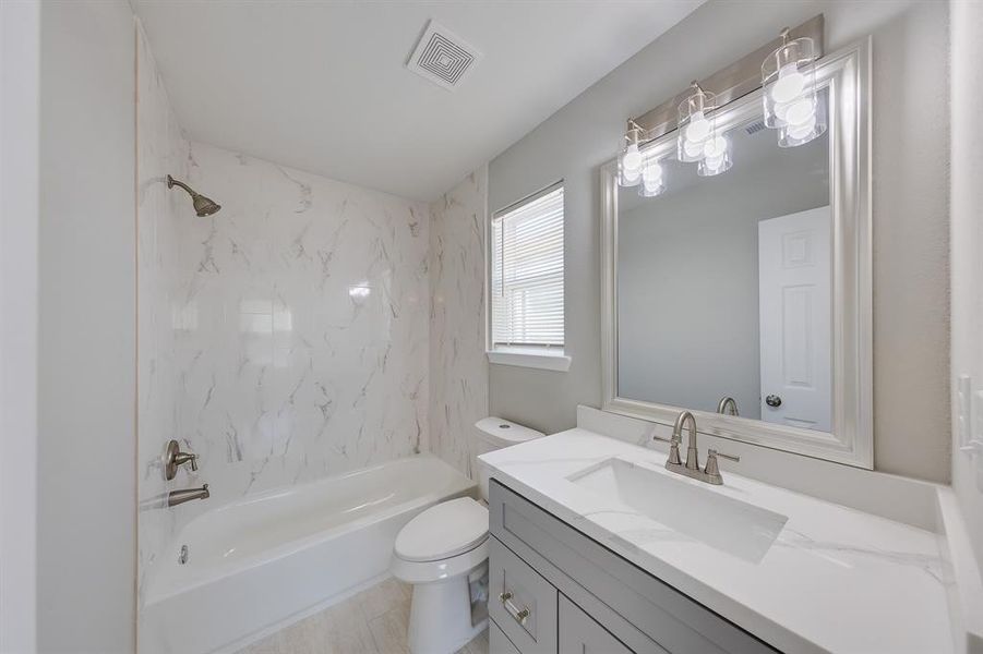 The primary bath exudes privacy and sophistication, showcasing elegant finishes that elevate the space. With a sleek design and high-quality fixtures, it offers a luxurious retreat for relaxation. Thoughtful details create a serene atmosphere, making this bathroom a perfect personal sanctuary.