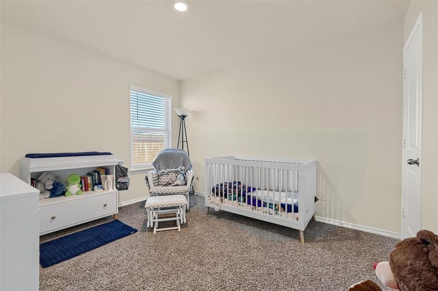 Carpeted bedroom with a crib