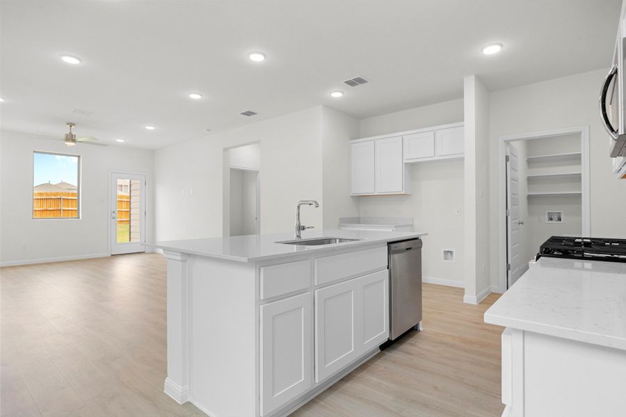 Kitchen in the Magnolia home plan by Trophy Signature Homes – REPRESENTATIVE PHOTO