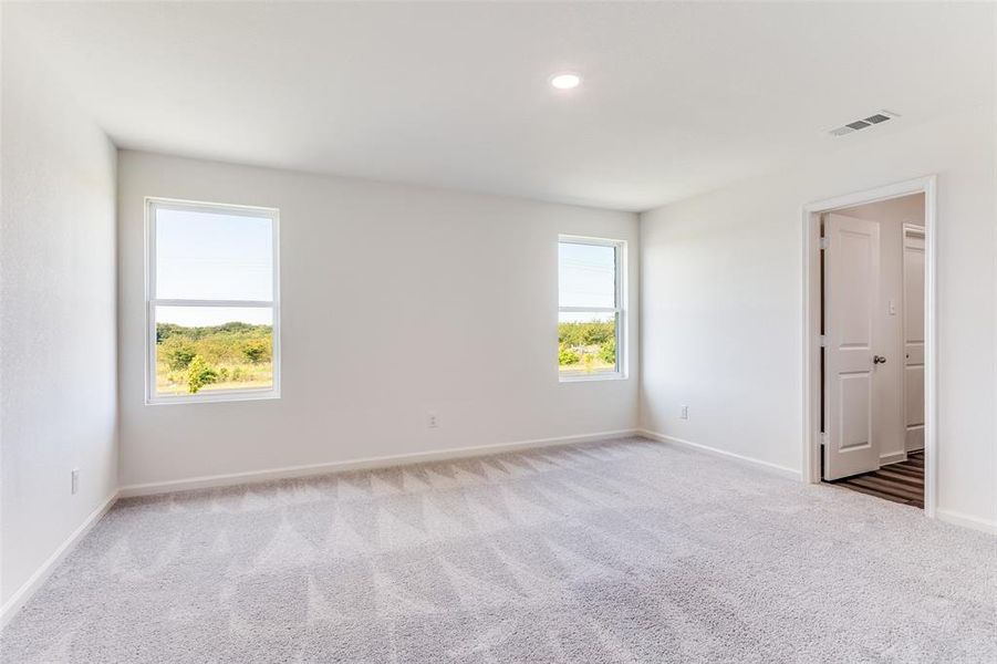 Carpeted spare room featuring baseboards and recessed lighting