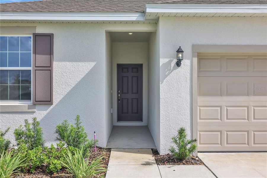 Front exterior of a new home in Willowbrook North, Winter Haven, FL, highlighting curb appeal (Image 1).