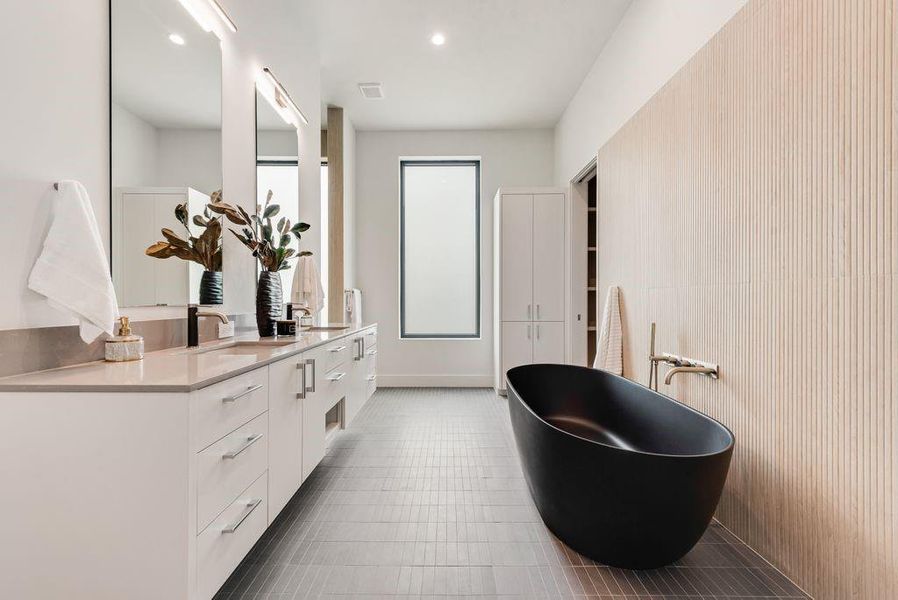 The spa-inspired bath features custom finishes and a calming, modern design.