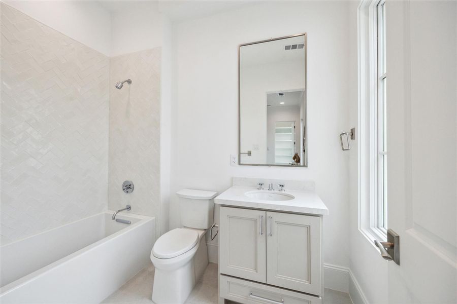 En-suite bath features Kohler Underscore alcove bath, Quartz countertops, and under-cabinet storage. En-suite bath features Kohler Underscore alcove bath, Quartz countertops, and under-cabinet storage.