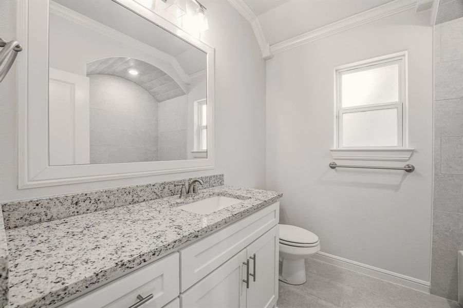 Full bath with vanity, ornamental molding, and light tile patterned floors Full bath with vanity, ornamental molding, and light tile patterned floors
