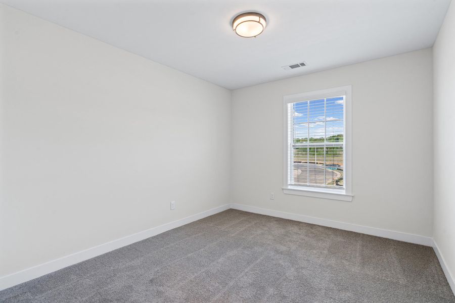 Carpeted empty room featuring baseboards Carpeted empty room featuring baseboards