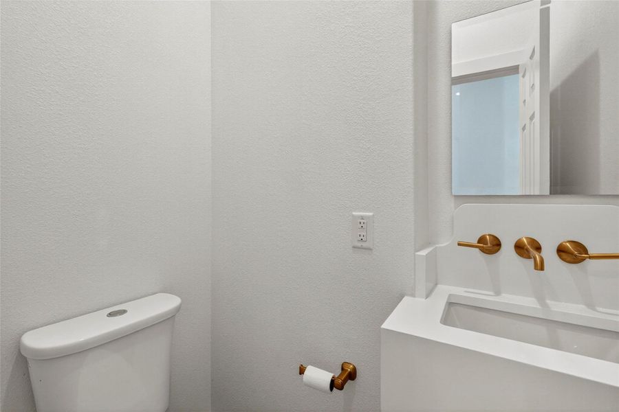 Bathroom featuring a textured wall and vanity