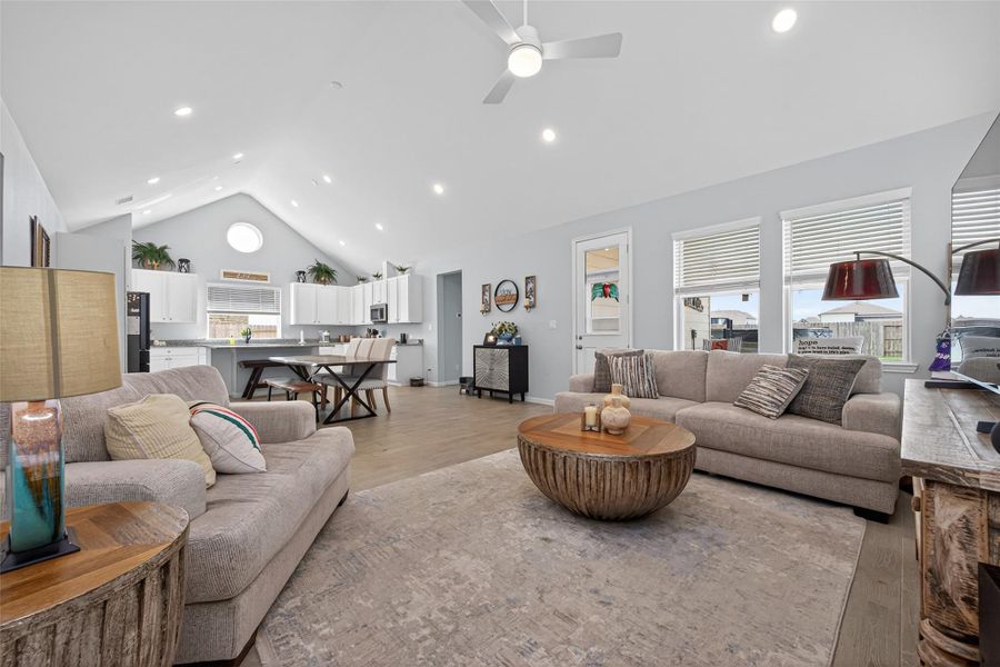 Open-concept living area connecting seamlessly to the kitchen and dining space