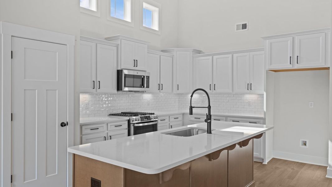 First-rate kitchen with a smaller island and superior cabinetry in a thoughtfully designed space