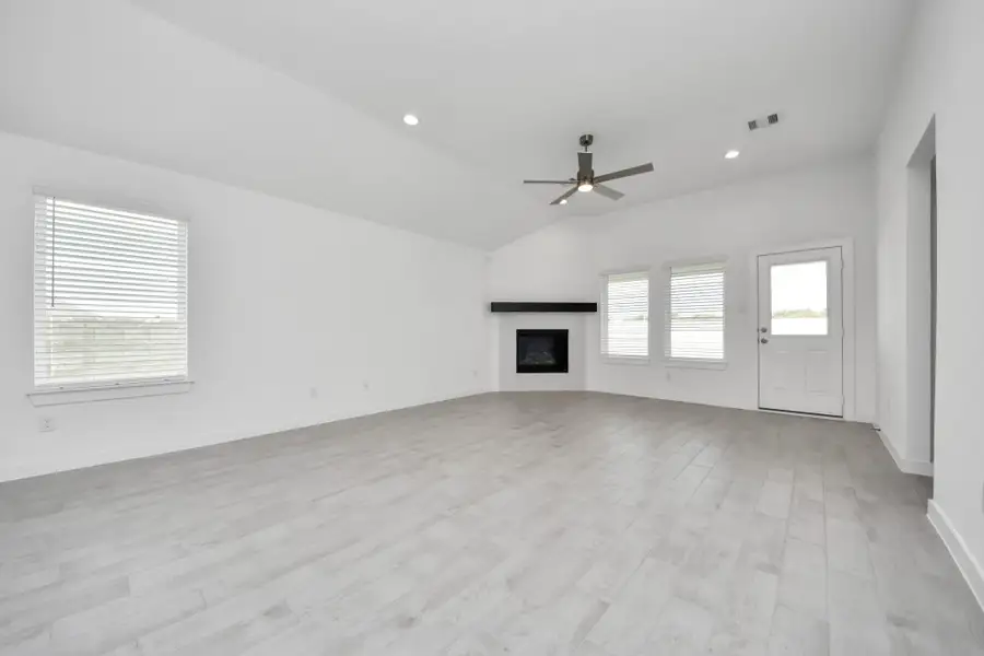 Take another glimpse into the heart of the home with this additional view of the family room—a sprawling space ready to accommodate all your gatherings. Sample photo of completed home with similar floor plan. Actual colors and selections may vary.