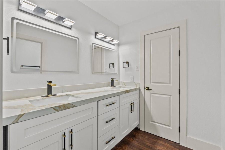 Spacious upstairs bath directly across from rooms one and two, featuring dual sinks and custom cabinetry.