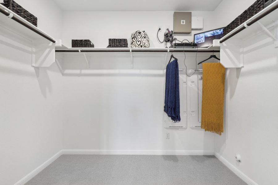 A white room with a shelf and a towel on the wall.