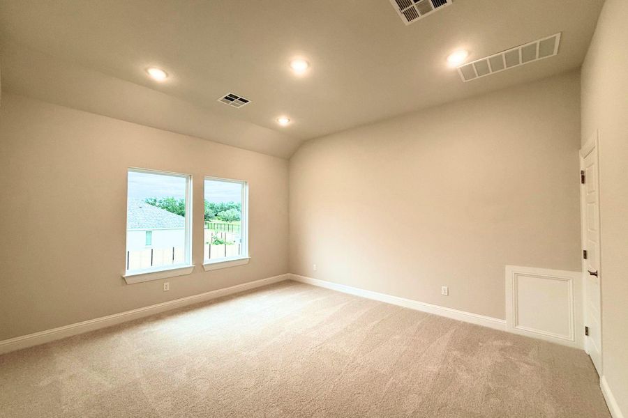 Recessed lighting illuminates this inviting room, featuring soft carpeting and a clear view to the outdoors. Recessed lighting illuminates this inviting room, featuring soft carpeting and a clear view to the outdoors.