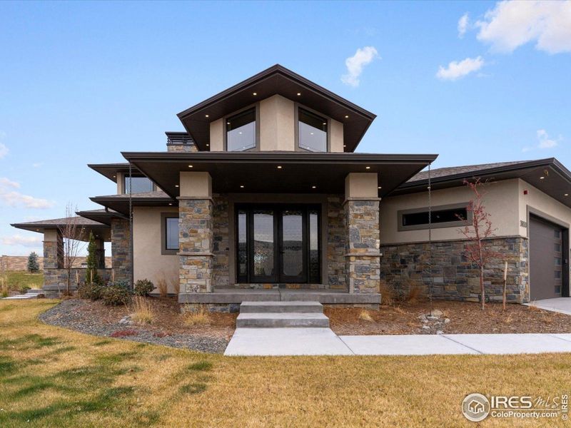Front exterior of a new home in Harmony, Timnath, CO, highlighting curb appeal (Image 26). Front exterior of a new home in Harmony, Timnath, CO, highlighting curb appeal (Image 26).