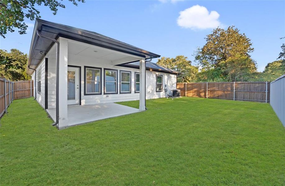 Rear view of property featuring a fenced backyard and a patio area