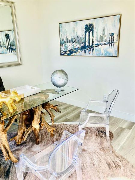 Chic home office space with modern furnishings and inspiring cityscape artwork.